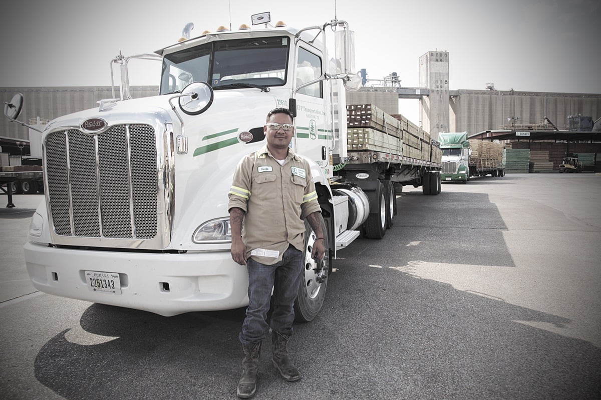 A person standing in front of a large truck
